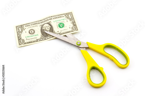 Scissors cutting dollar.