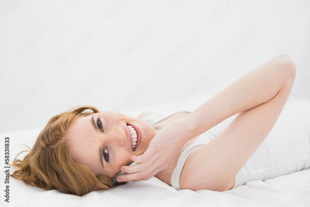 Portrait of a relaxed woman using mobile phone in bed Portrait of a relaxed woman using mobile phone in bed