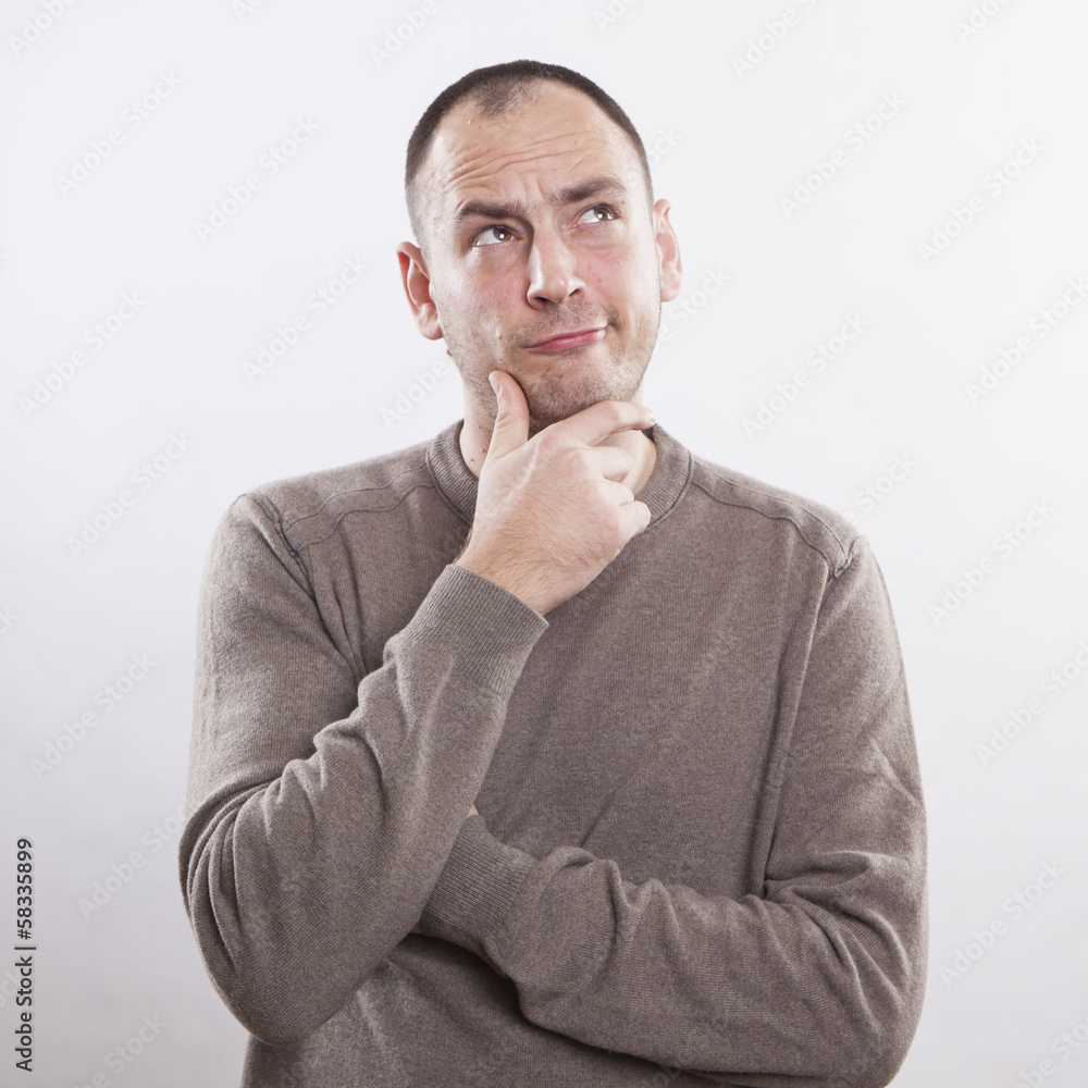 Portrait of a thoughtful man isolated over white background Portrait of a thoughtful man isolated over white background
