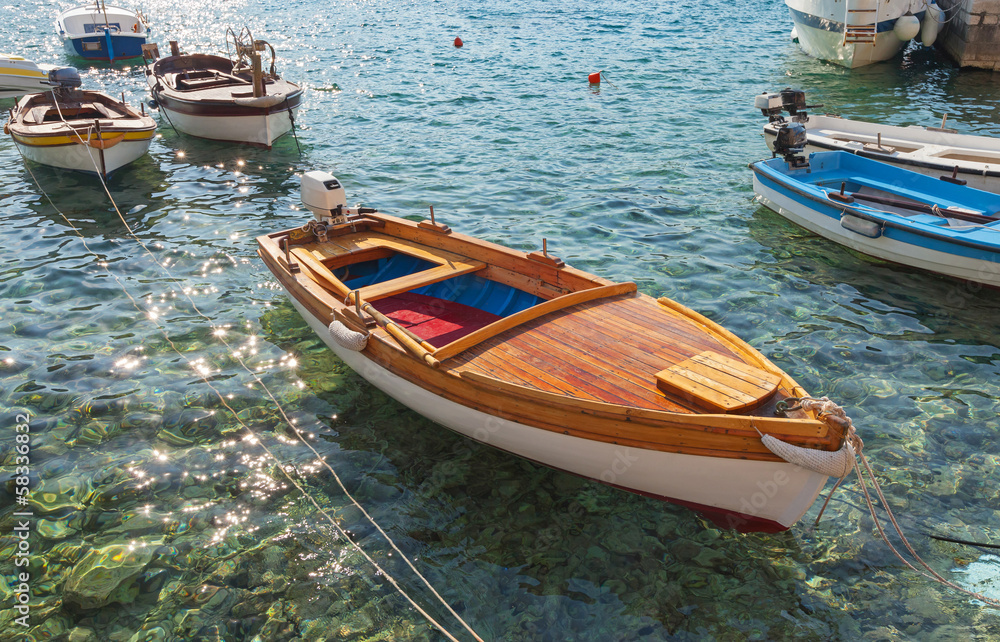 Wooden fishing boats float moored in Adriatic sea