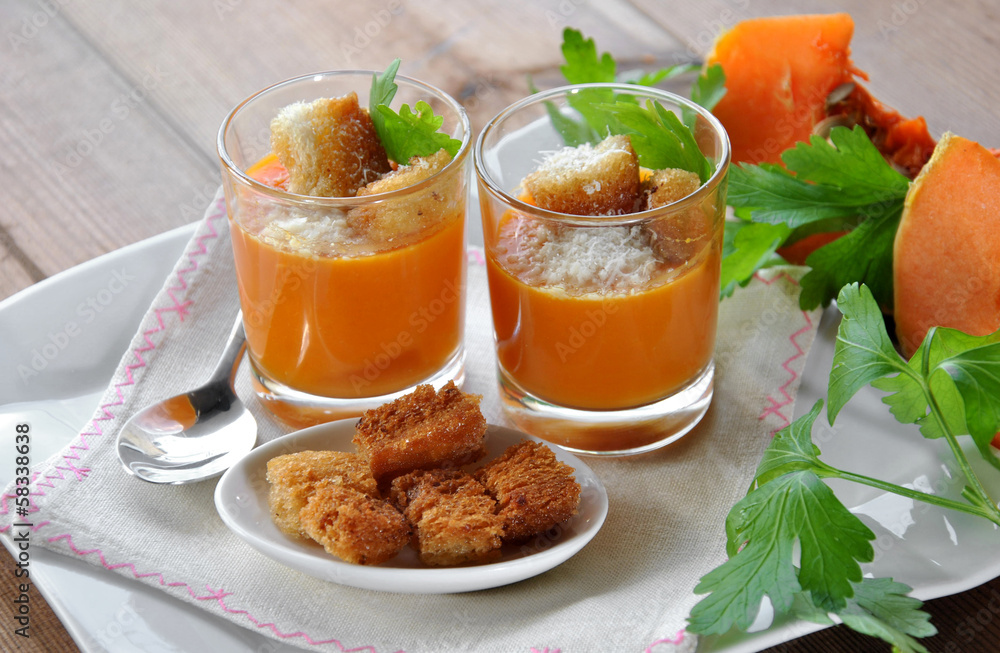two glasses with pumpkin soup and bread two glasses with pumpkin soup and bread