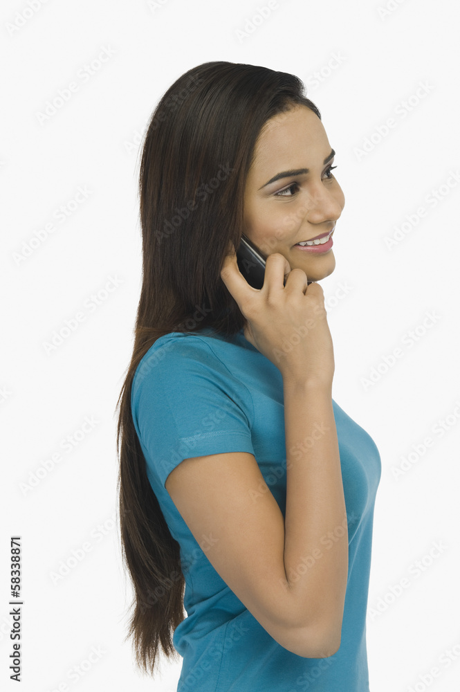 Woman talking on a mobile phone Woman talking on a mobile phone