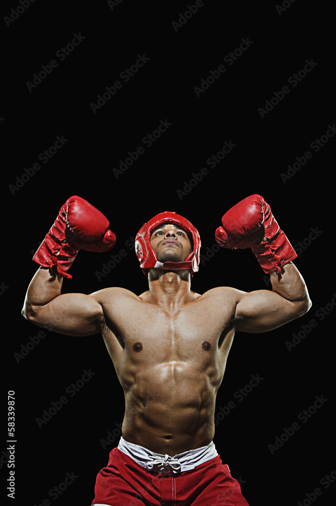 Male boxer with arms over his head