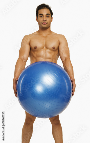 Portrait of a man holding a fitness ball