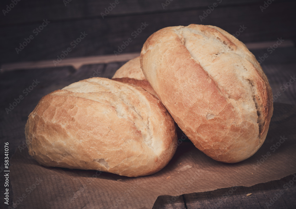 Wheat bread roll on a cutting board Wheat bread roll on a cutting board