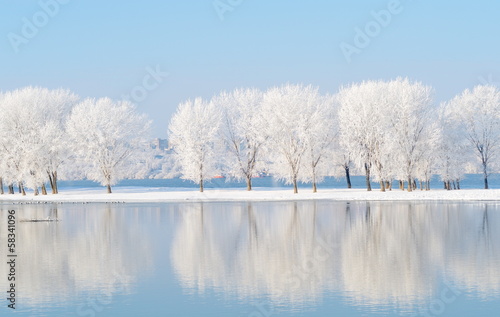winter landscape with beautiful reflection in the water © bereta