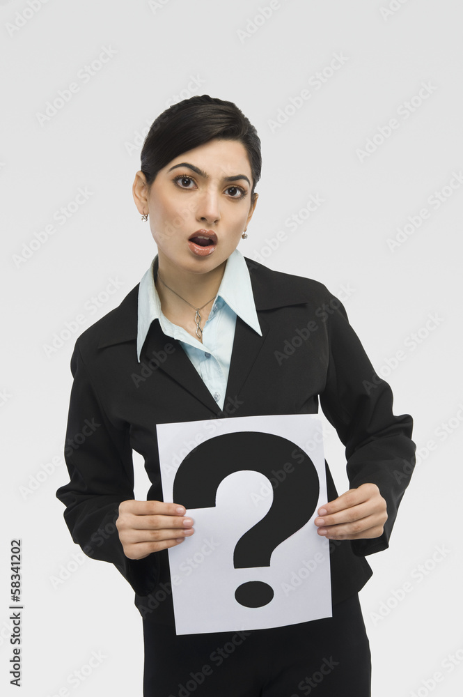 Businesswoman holding a card with question mark Businesswoman holding a card with question mark