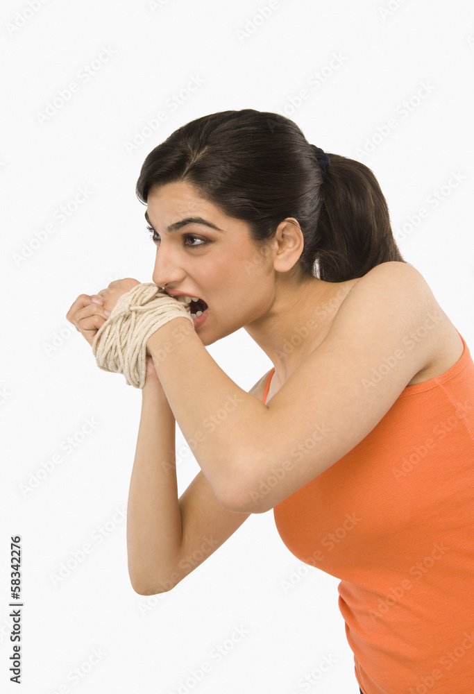 Woman's hands tied with a rope Woman's hands tied with a rope