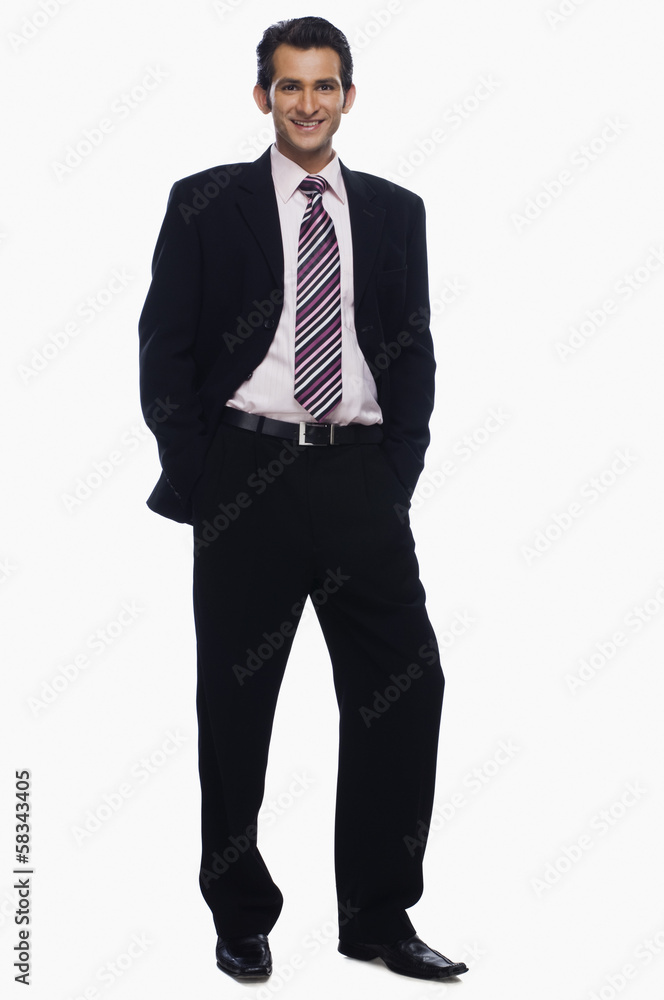 Portrait of a businessman standing with his hands in pockets Portrait of a businessman standing with his hands in pockets