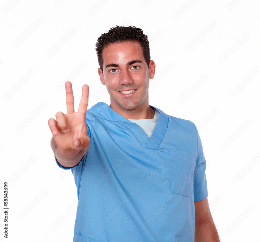 Handsome nurse man with winning sign Handsome nurse man with winning sign