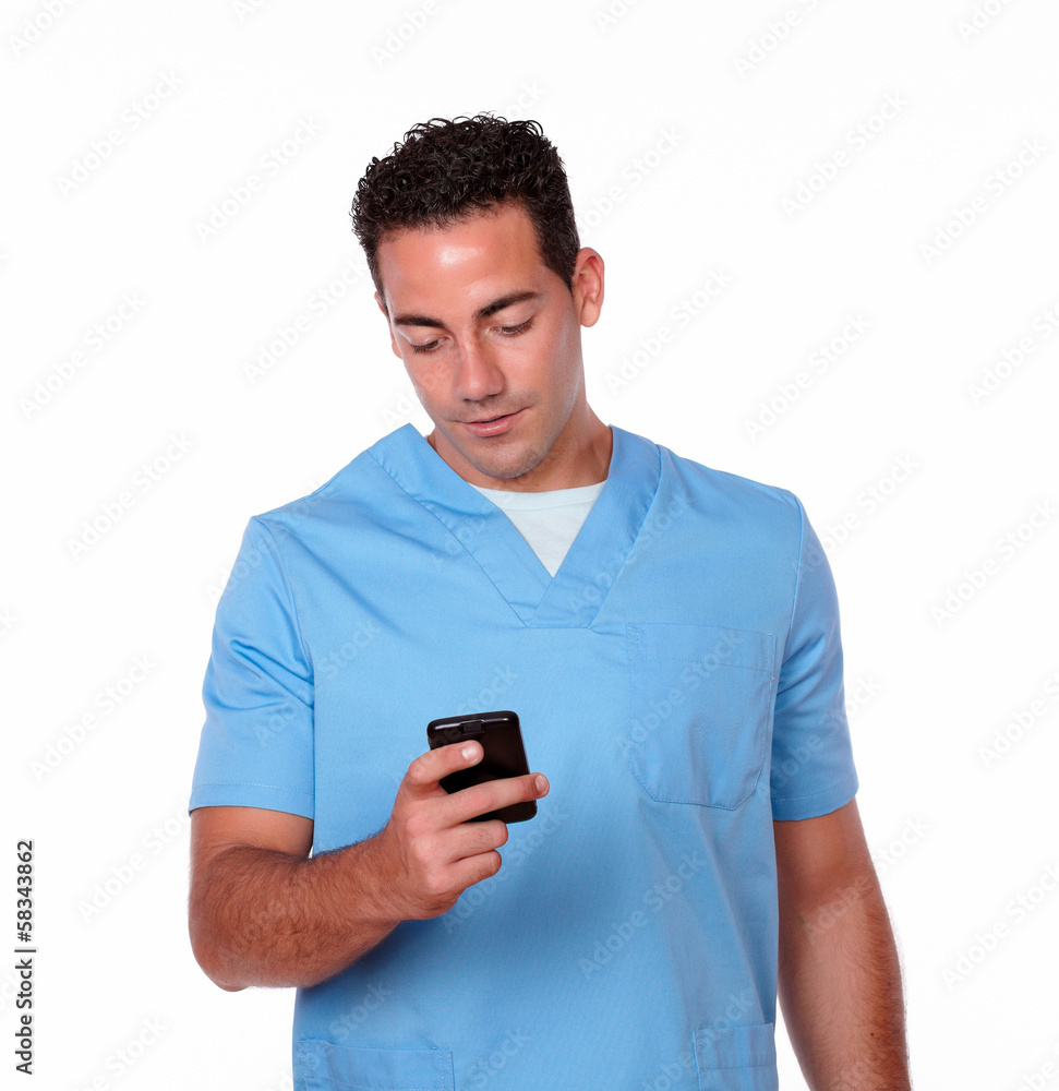 Handsome nurse guy texting with his cellphone Handsome nurse guy texting with his cellphone