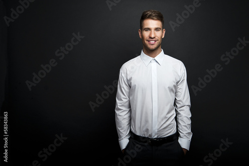 Portrait of a young handsome man a white shirt