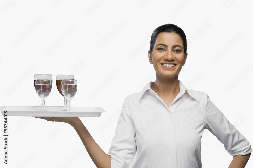 Air hostess carrying a tray of wine glasses Air hostess carrying a tray of wine glasses