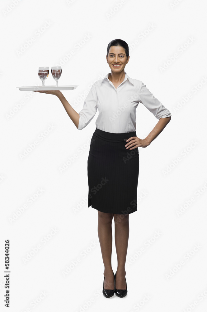 Air hostess carrying a tray of wine glasses Air hostess carrying a tray of wine glasses