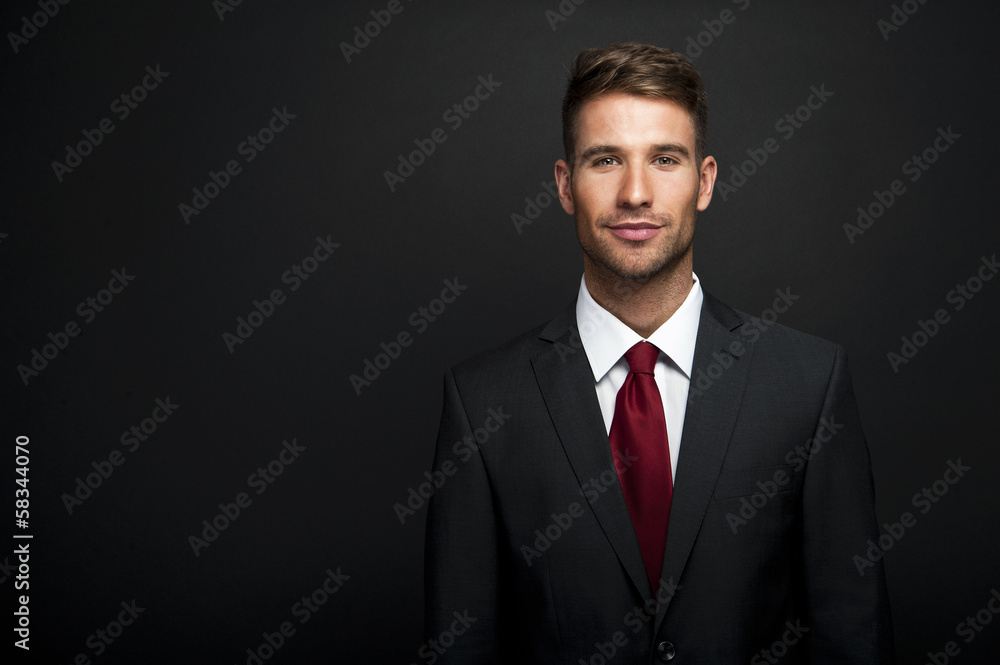 Businessman standing on dark gradient background Businessman standing on dark gradient background