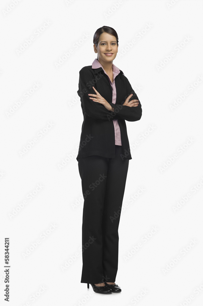 Businesswoman standing with her arms crossed and smiling Businesswoman standing with her arms crossed and smiling