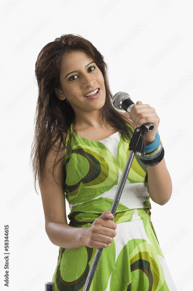 Portrait of a woman singing into a microphone Portrait of a woman singing into a microphone