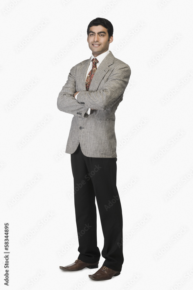 Portrait of a businessman standing with arms crossed Portrait of a businessman standing with arms crossed