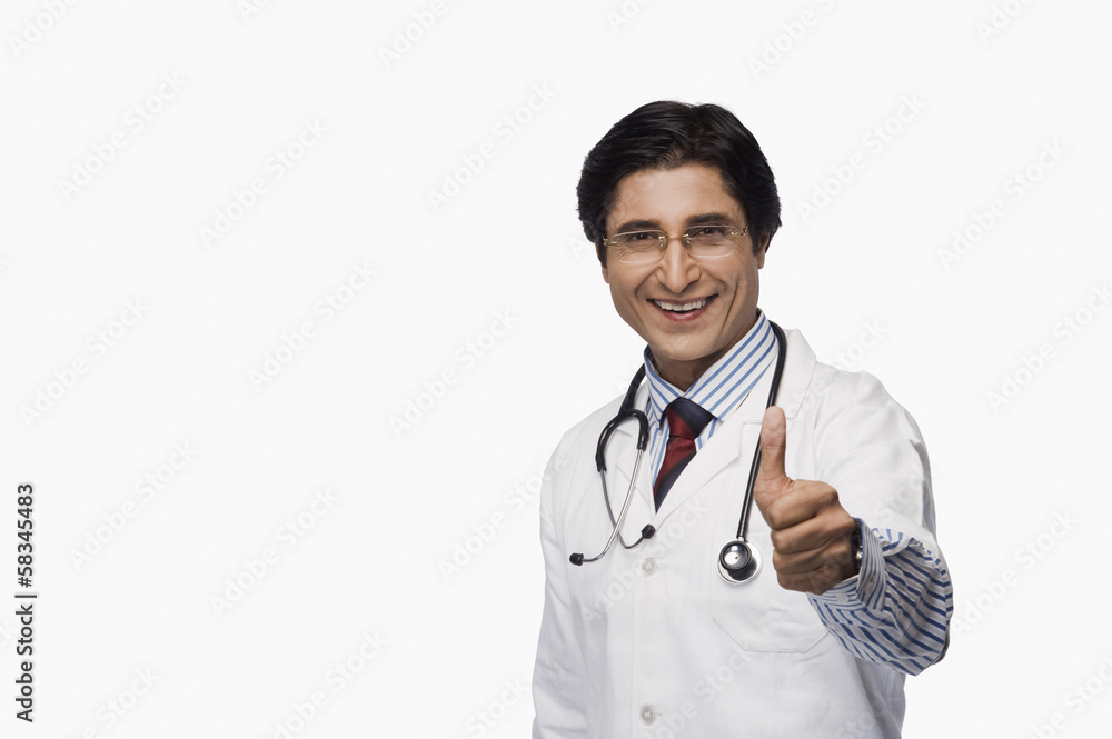 Portrait of a doctor showing thumbs up and smiling Portrait of a doctor showing thumbs up and smiling
