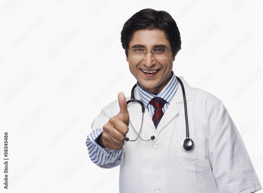 Portrait of a doctor showing thumbs up and smiling Portrait of a doctor showing thumbs up and smiling