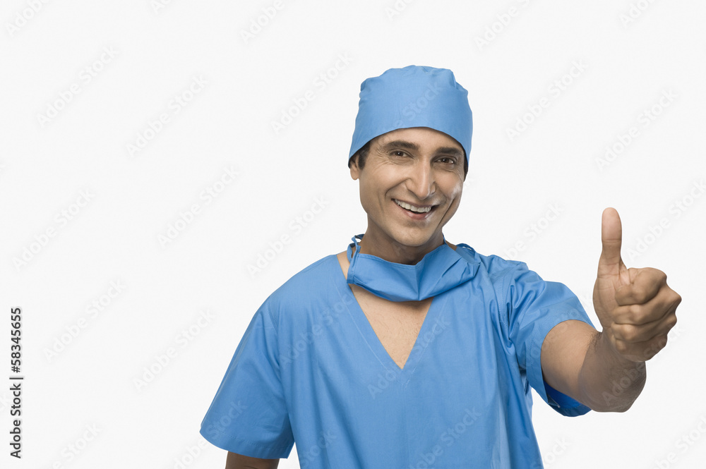 Portrait of a surgeon showing thumbs up and smiling Portrait of a surgeon showing thumbs up and smiling