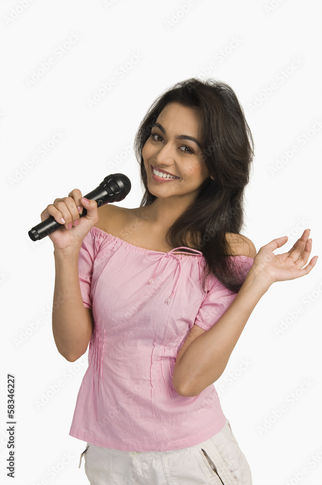 Portrait of a woman singing into a microphone Portrait of a woman singing into a microphone