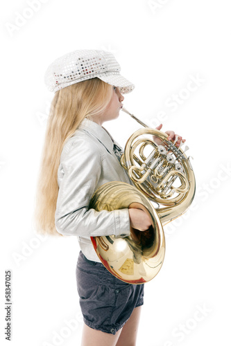young girl with cap playing french horn