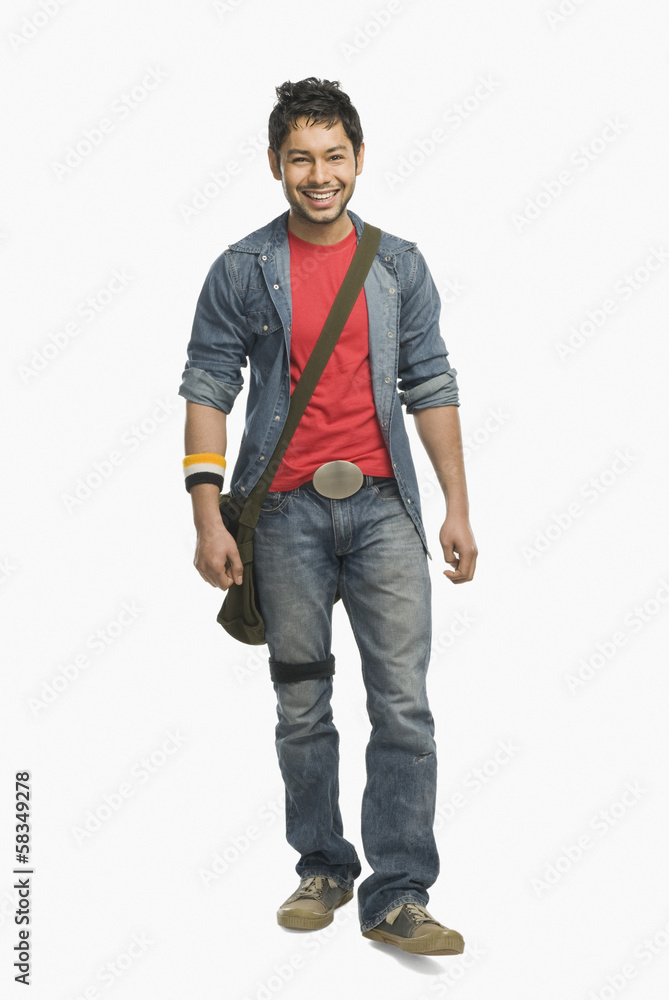 University student with a shoulder bag and smiling University student with a shoulder bag and smiling