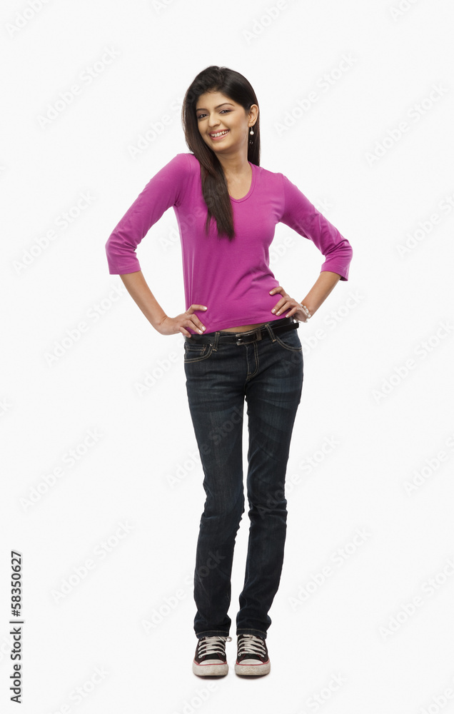 Close-up of a woman standing with arms akimbo Close-up of a woman standing with arms akimbo