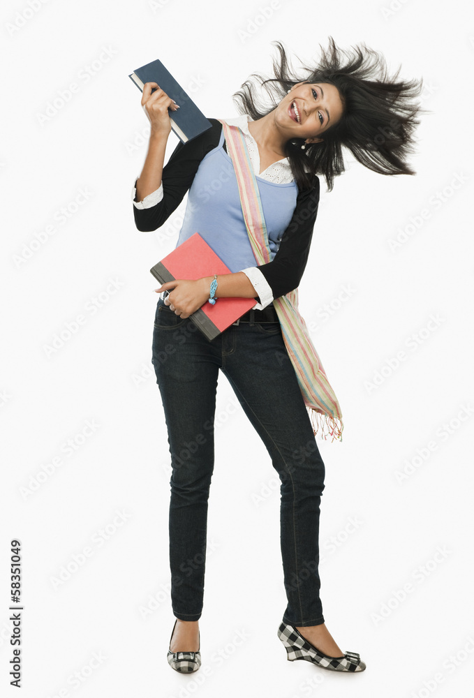 University student holding books and looking excited University student holding books and looking excited