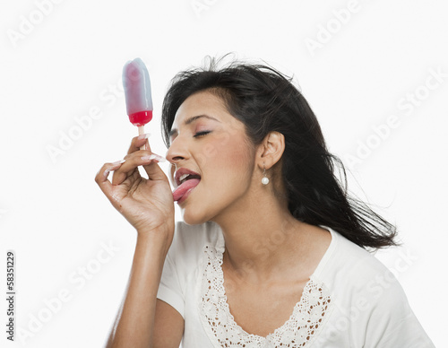 Woman licking ice cream on her hand