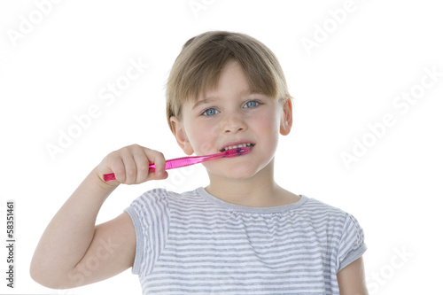 beautiful kid brushes her teeth