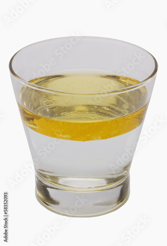 Oil floating on water surface in a glass