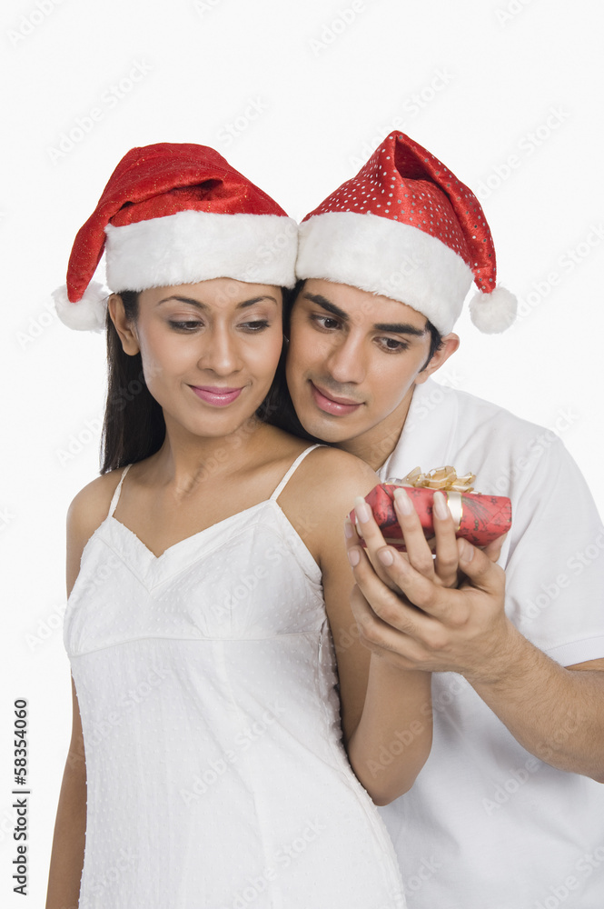 Man giving a Christmas present to his girlfriend Man giving a Christmas present to his girlfriend