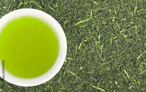 Wallpaper Mural Cup of green tea and green tea leaves background Torontodigital.ca