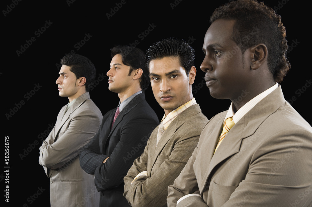 Portrait of a businessman standing with his colleagues Portrait of a businessman standing with his colleagues