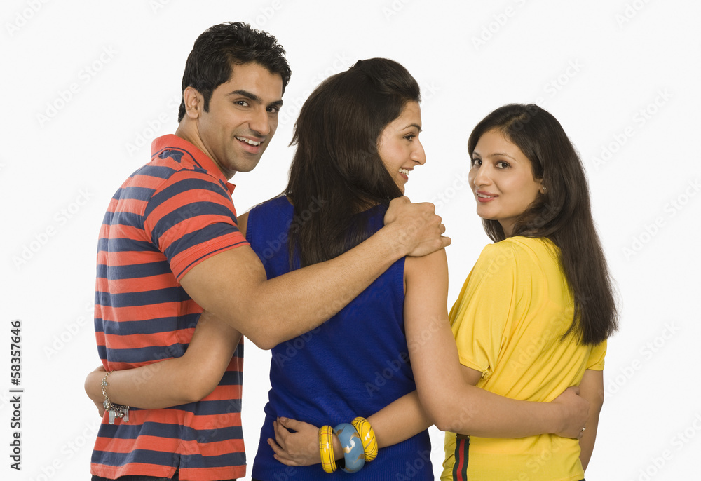 Rear view of three friends standing and smiling Rear view of three friends standing and smiling