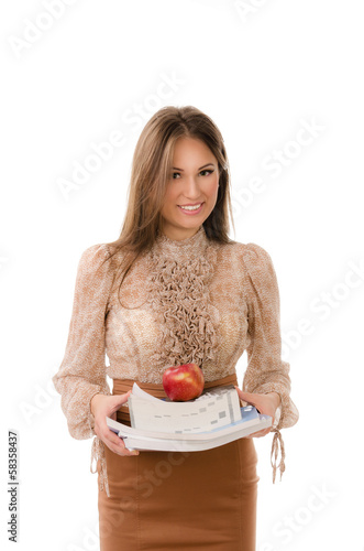 Teacher carrying a stack of books with an apple on top photo