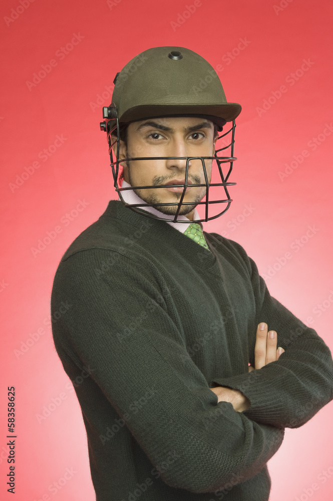 Businessman wearing a cricket helmet Businessman wearing a cricket helmet