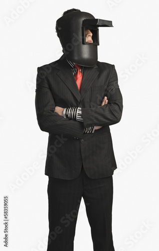 Businessman wearing a welding mask