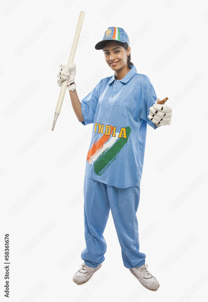 Portrait of a female cricketer holding a cricket stump and cheering Portrait of a female cricketer holding a cricket stump and cheering