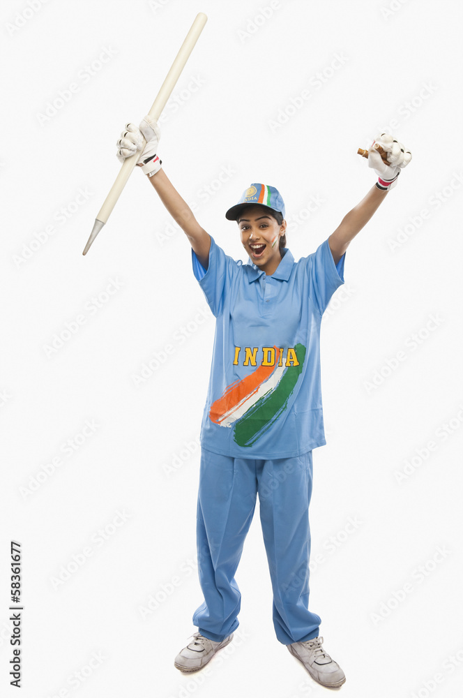 Portrait of a female cricketer holding a cricket stump and cheering Portrait of a female cricketer holding a cricket stump and cheering