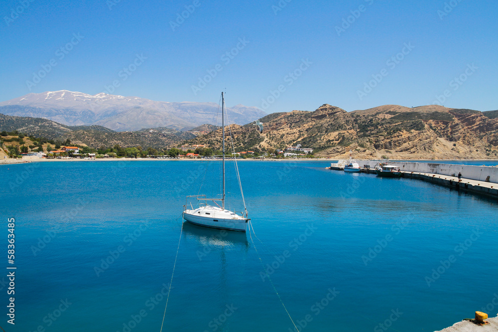 Small sailing boat anchored at a small harbour south of Crete