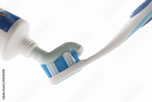 Toothpaste being squeezed onto toothbrush