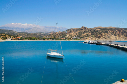 Small sailing boat anchored at a small harbour south of Crete