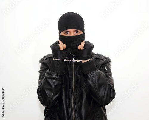 Masked criminal with handcuffs