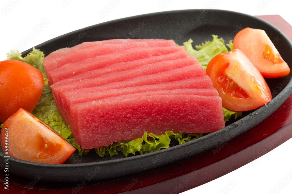 fresh raw tuna fish pieces on plate isolated