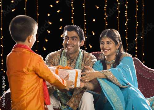 Photography Couple giving Diwali gift to their son