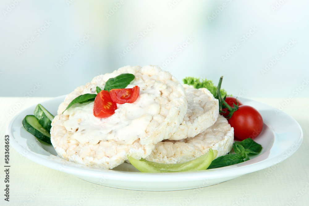 Tasty crispbreads with vegetables on white table Tasty crispbreads with vegetables on white table