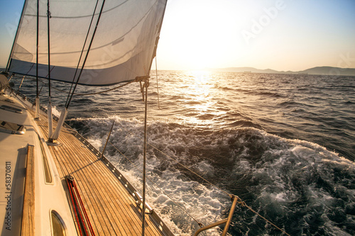 Luxury yachts. Yacht sailing towards the sunset. © De Visu
